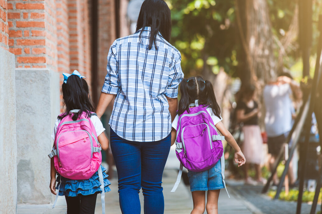 Mother walking children to school in Croatia